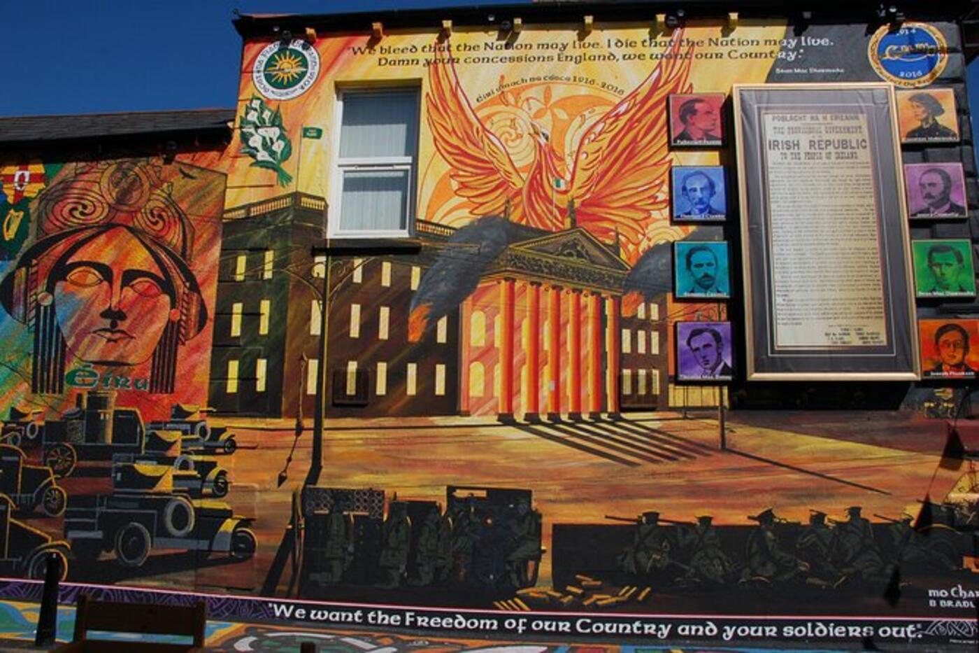 Black taxi parked in front of Bobby Sands mural on the Falls Road, Belfast